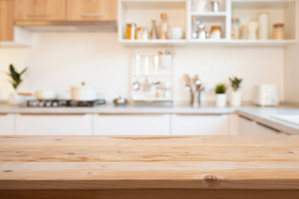 istock Brown wooden table for product montage on blur kitchen counter interior background 2194170531