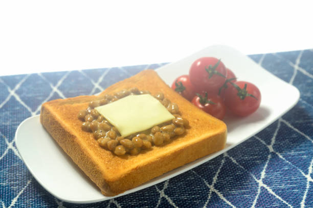Female hands holding a sandwich with honey and peanut butter spreading on piece of white bread toast, close up. Typical snack food, food lifestyle, domestic life, american breakfast