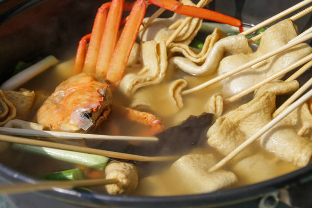 Fish cake skewers and hot soup in a pot