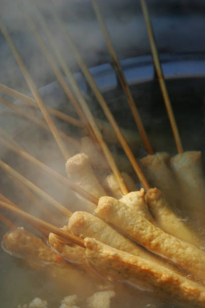Fish cake skewers and hot soup in a pot