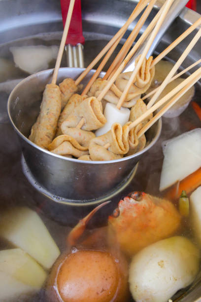 Fish cake skewers and hot soup in a pot