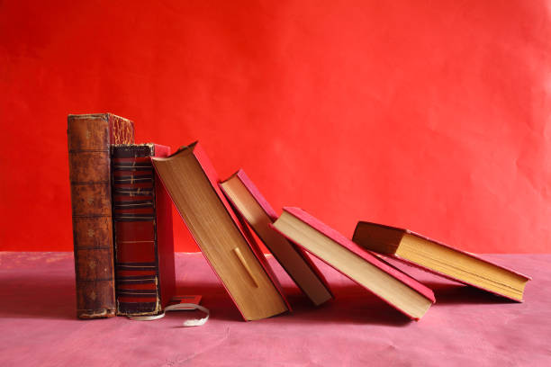 istock Row of red books on red grungy background, reading, learning, education knowledge is power or home office concept 2194171319