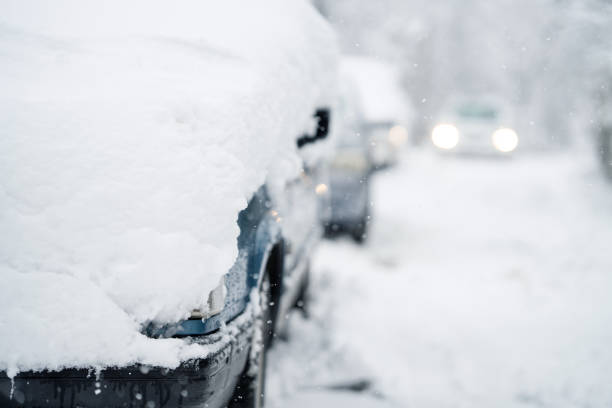 Parked car covered with snow  during snow storm.