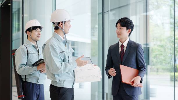 A man in work clothes having a meeting with a client stock photo