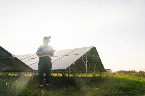istock Female farmer with digital tablet on a modern farm using solar panels. 2194174377