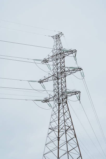 istock A tall High Voltage Power Line Tower rises against a slightly overcast sky with clouds 2194175784