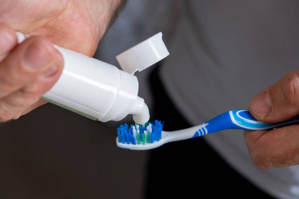 istock Brushing teeth adult man hand close up 2194178452