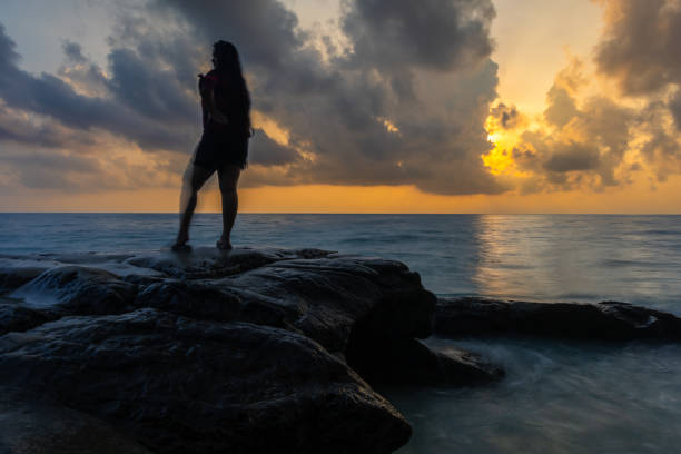 istock people presence illusion effect long exposure blur with dramatic sunrise sky over sea horizon 2194179544