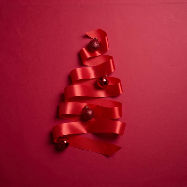 istock Christmas tree made of red ribbons on red background, element for design with copy space for text or image 2194179944