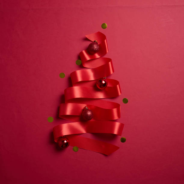 istock Christmas tree made of red ribbons on red background, element for design with copy space for text or image 2194179952