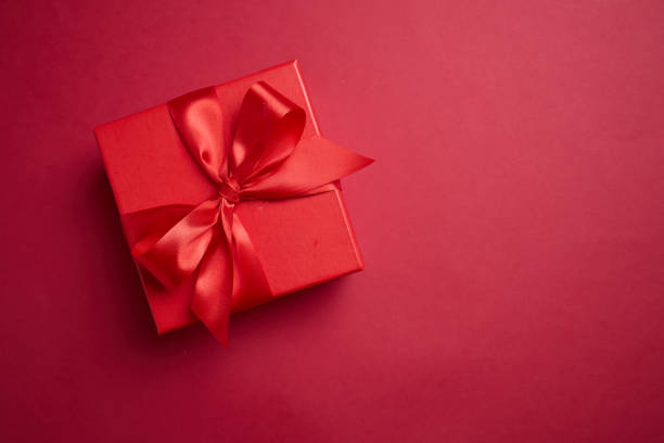 istock Red gift box with a red bow on a red background, element for design with copy space for text or image 2194180173