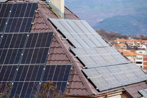 istock Solar panels on both sides of a house roof 2194180254