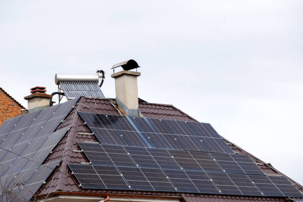 istock Solar panels on both sides of a house roof 2194180297
