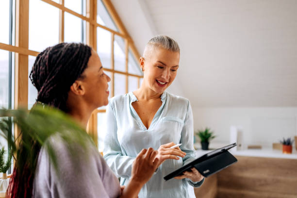 istock Two well dressed businesswomen using digital tablet at the office together 2194181110