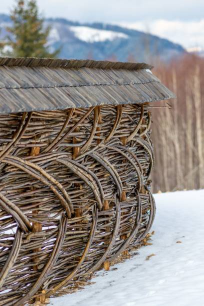 istock Of a rustic woven wooden fence with a snowy mountain backdrop 2194181155