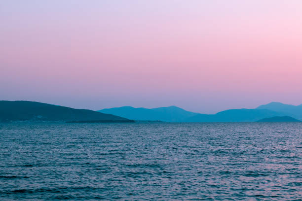 istock Surreal evening red pink sea landscape, mountains on the background 2194181247