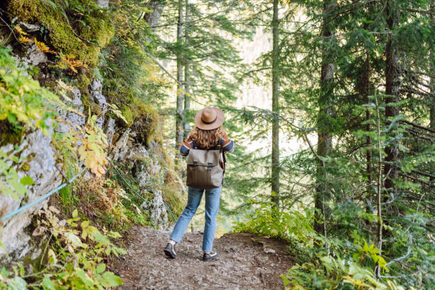 istock Woman with backpack hiking outdoors in the Forest. 2194181434