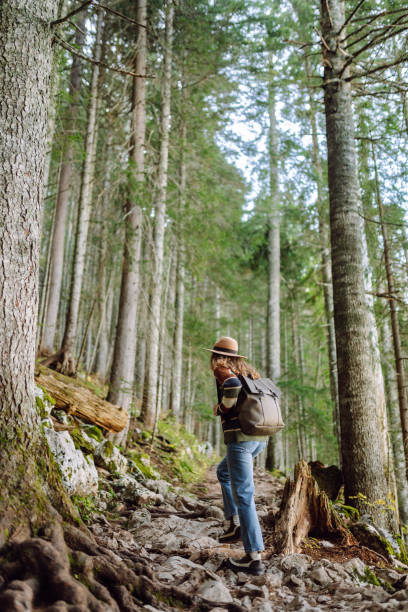 istock Woman with backpack hiking outdoors in the Forest. 2194181445