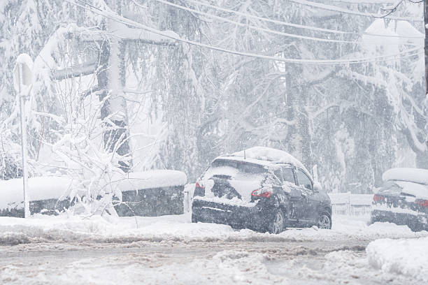 istock Parked car covered with snow during snow storm. 2194182672