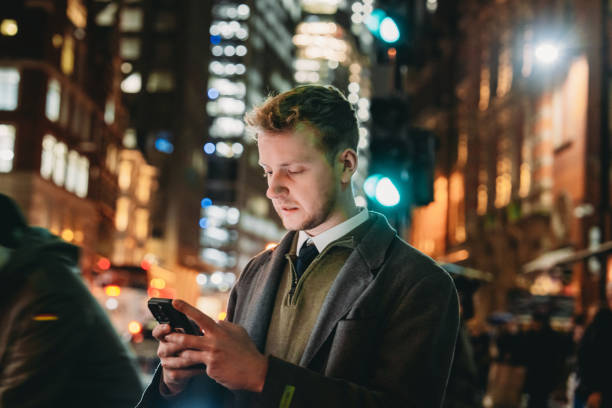 istock Businessman using smartphone at night in london 2194183512