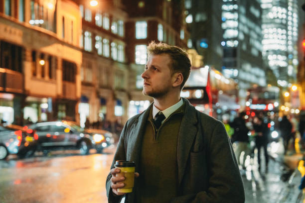 istock Businessman drinking coffee and walking in London at night 2194183542