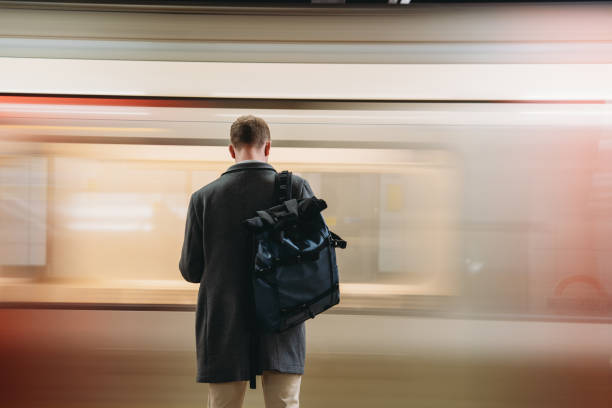 istock Businessman waiting for a passing train in a subway station 2194183576