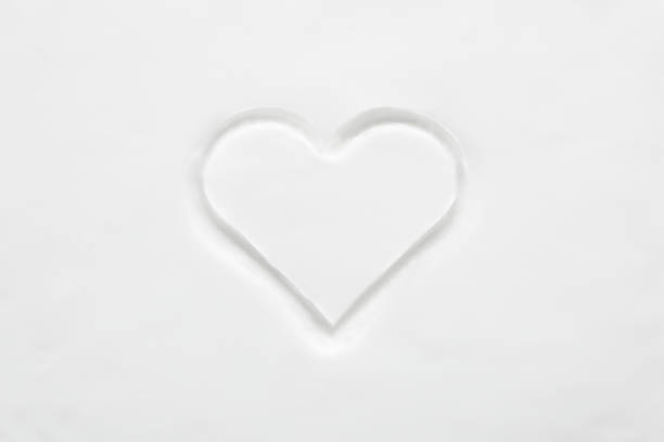 istock Created soft white heart shape on body skin cream background. Closeup. Top down view. 2194183736
