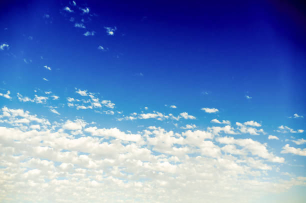 The sky is blue with a few clouds scattered throughout. The clouds are white and fluffy, giving the sky a peaceful and serene appearance