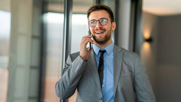 istock Young happy successful young businessman working and smiling at corporate office 2194184209