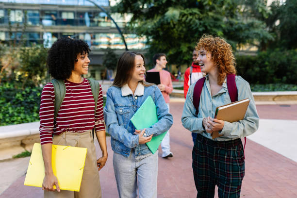 istock Young group of university students walking at college campus 2194188138