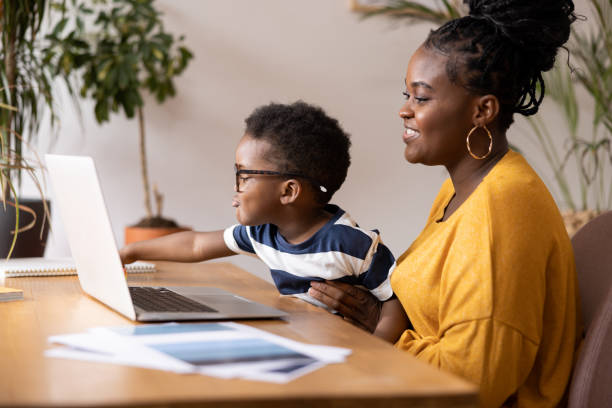 istock Mother and son using laptop at home for homeschooling or entertainment 2194188883