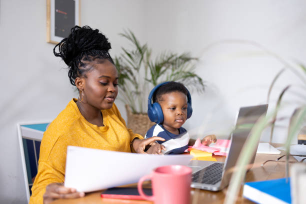 istock Mother working from home while taking care of her son 2194188884