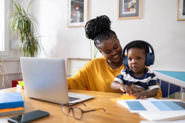 istock Mother working from home while taking care of her son 2194188892