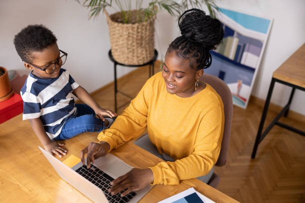 istock Young mother working from home with her son looking on 2194188895