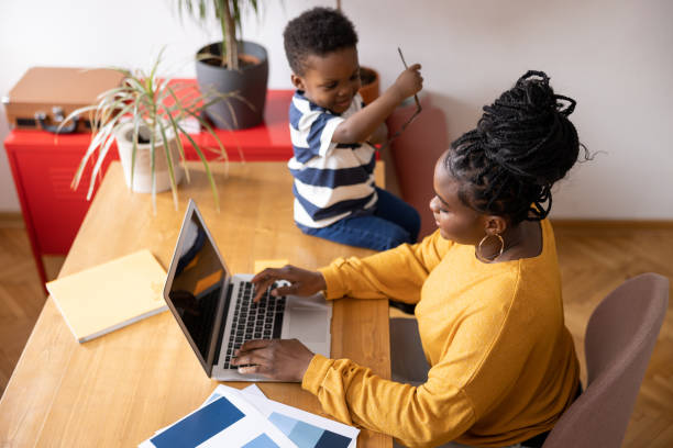 istock Mother working from home while taking care of her son 2194188901