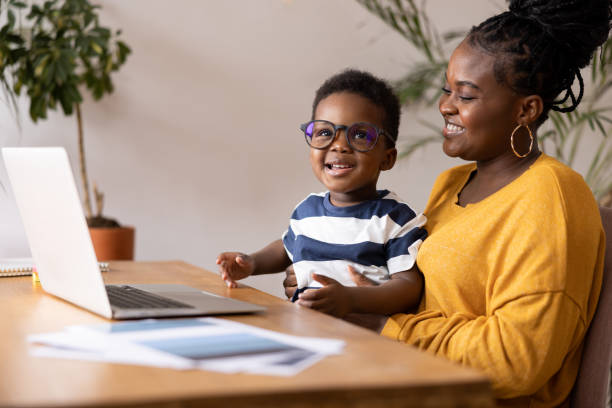 istock Mother and child sharing a moment of joy while using laptop at home 2194188904