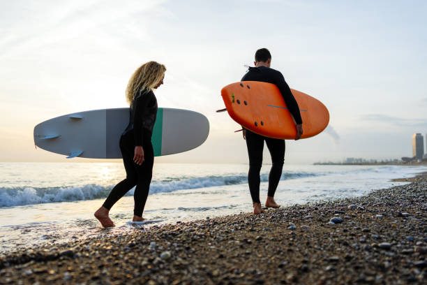 istock Young people having fun, enjoying their vacations outdoors at the beach with surfboards. Sport, surf 2194190170
