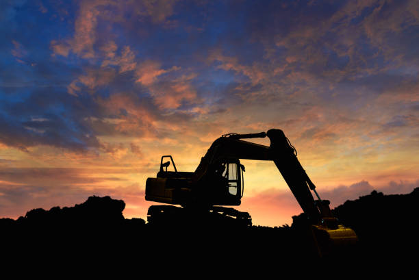 istock Crawler excavators silhouette are digging the soil in the construction site. 2194190815