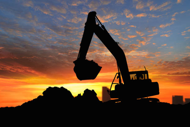 istock Crawler excavators silhouette are digging the soil in the construction site. 2194190821