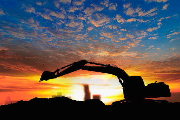 istock Crawler excavators silhouette are digging the soil in the construction site. 2194190879