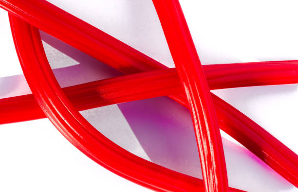 istock Intertwined red licorice sticks on white background 2194190974