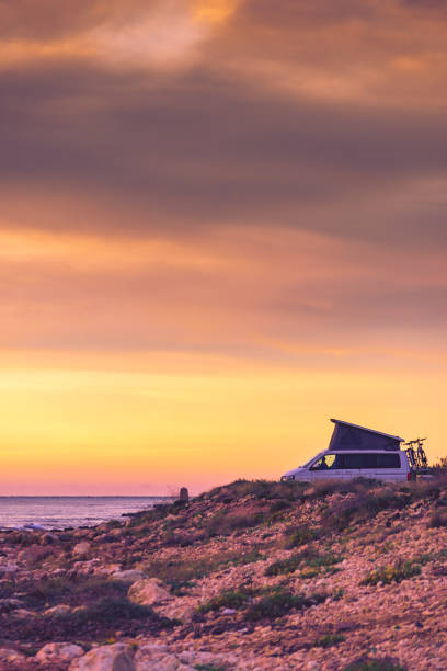 istock Van camper with tent on roof top camp on nature 2194192266