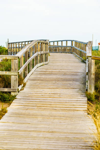 istock Wooden path to beach sea water. 2194192765