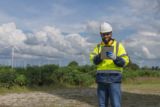 istock Survey Team Alternative energy for future. Engineers survey and checking wind turbines in sunset. Wind Turbine Renewable energy technology and sustainability. 2194192873