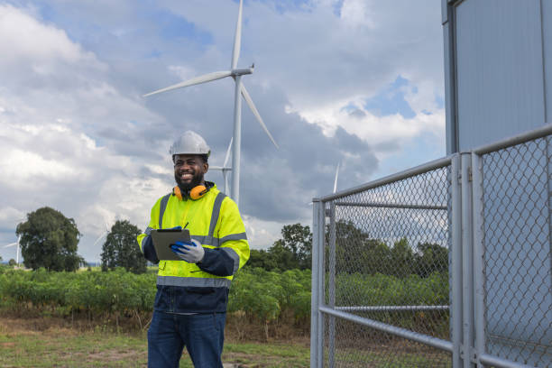 istock Survey Team Alternative energy for future. Engineers survey and checking wind turbines in sunset. Wind Turbine Renewable energy technology and sustainability. 2194192899