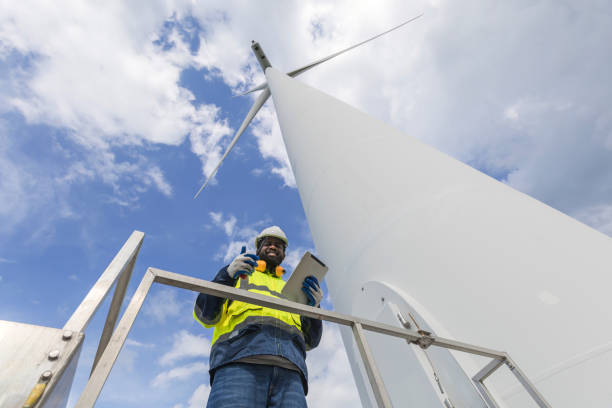 istock Survey Team Alternative energy for future. Engineers survey and checking wind turbines in sunset. Wind Turbine Renewable energy technology and sustainability. 2194192925