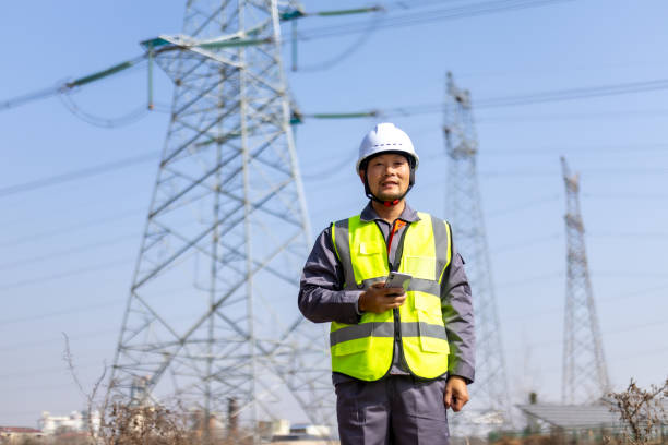 istock Power engineer working in front of high voltage electricity tower 2194192976