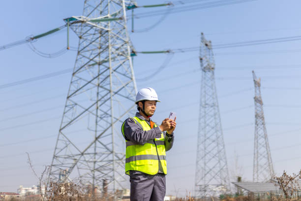 istock Power engineer working in front of high voltage electricity tower 2194193015