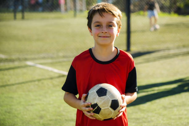istock Young Boy Smiling With Soccer Ball Outdoors on the Field 2194193283