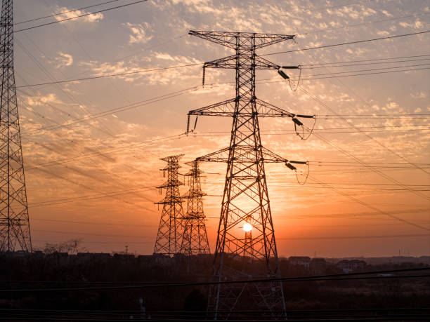 istock Sunset silhouette of high voltage transmission lines 2194193541
